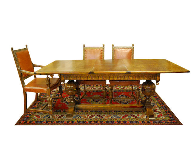 An oak extending refectory-type table and six chairs, early 20th Century The table with ivorine label reading 'The Ee-zi-way One Motion Extending Dining Table'