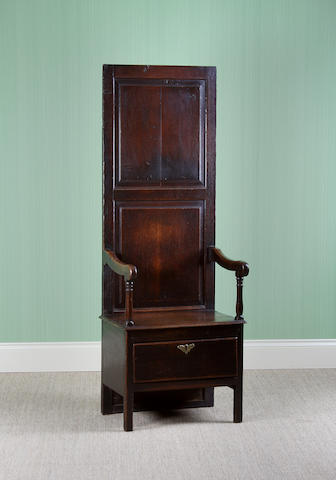 A rare mid-18th Century oak hall porter's chair.