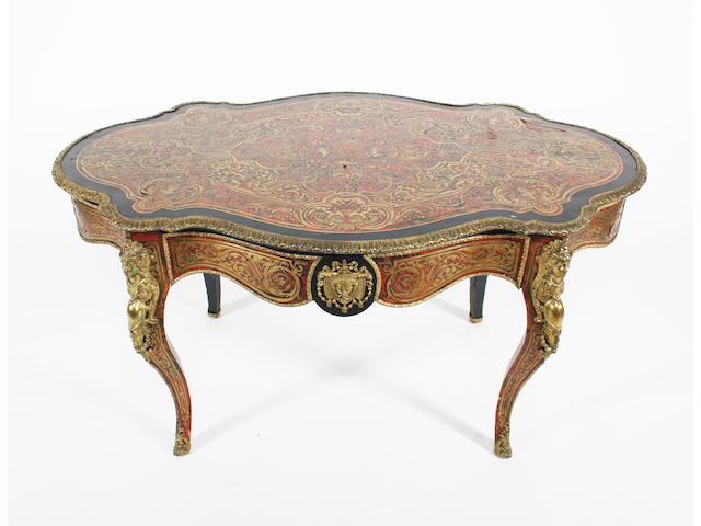 A mid/late 19th century French Louis XV style ebonised, Boulle scarlet tortoiseshell and cut brass inlaid and cast brass mounted bureau plat