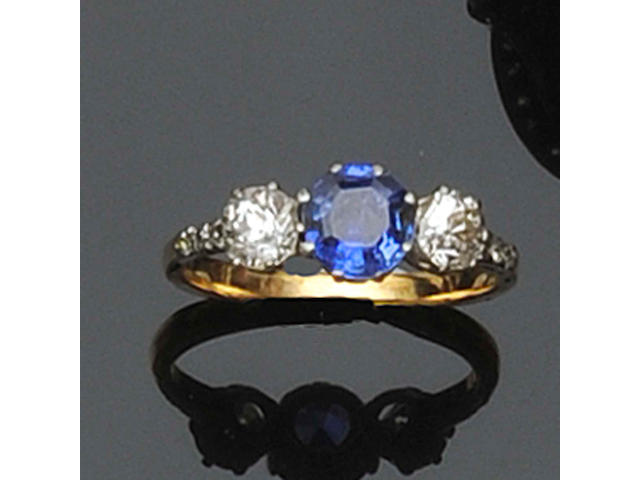 A three stone sapphire and diamond ring