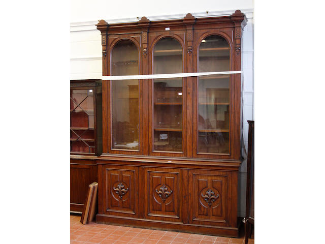 A Victorian mahogany library bookcase,with breakfront cornice above three glazed panel, doors enclosing adjustable shelves and cupboard base under, 265cm high x 186cm wide.