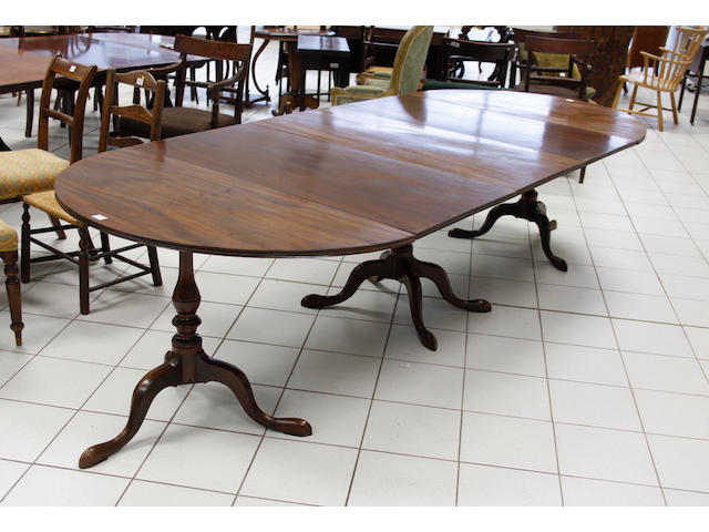 A Georgian style mahogany triple pillar dining table,