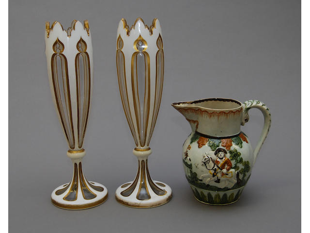 A Pratt ware jug and a pair of overlaid vases