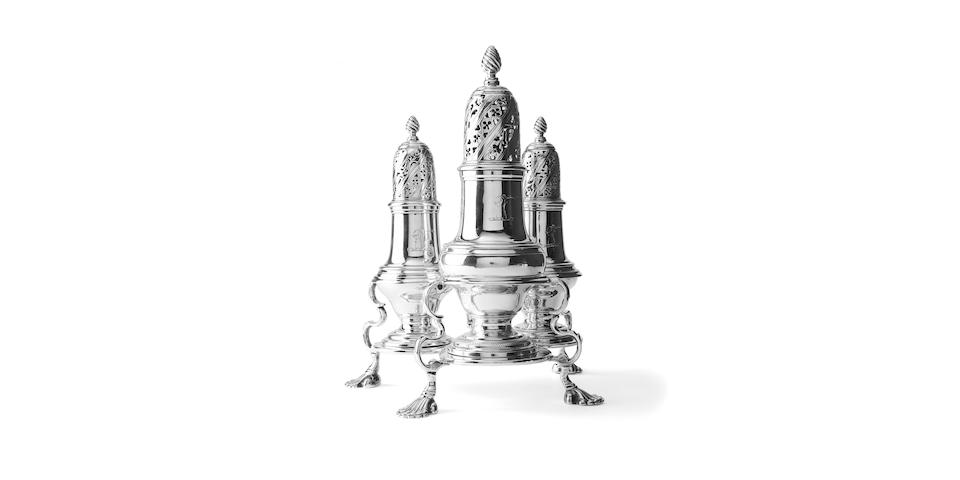 A George III three piece silver sugar caster set on stand By John Delmester, London 1761