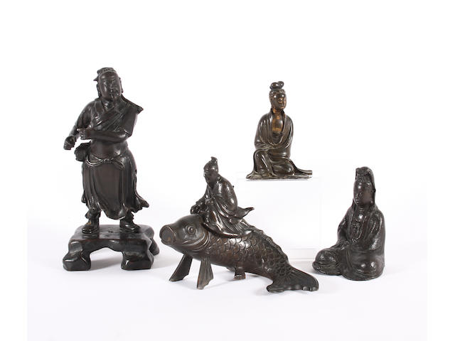 Three Chinese bronze figures and a Japanese example