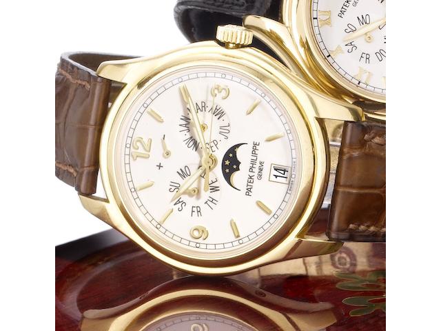 Patek Philippe. A fine 18ct gold automatic centre seconds wristwatch with annual calendar, moon phases and 48 hour power reserve, together with Certificate of Origin and fitted wooden boxAnnual Calendar, Ref:5146J, Case No.4366268, Movement No.3420928,  Sold May 21st 2007