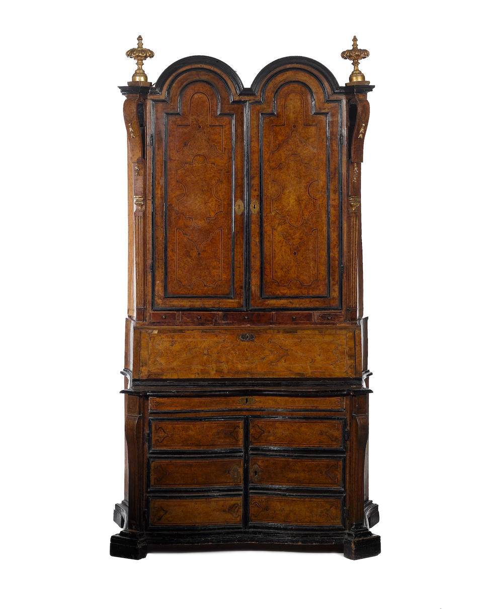 A rare pair of North Italian second-quarter 18th century parcel-gilt, walnut, burr-walnut, olivewood, ebonised and parquetry double-domed bureau-cabinets