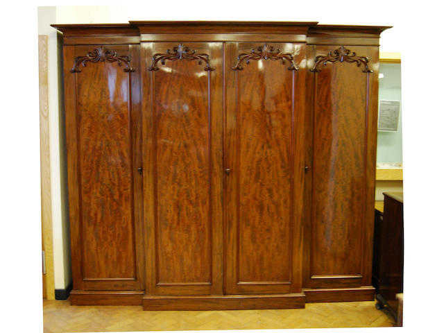 A large and impressive early Victorian mahogany breakfront wardrobe