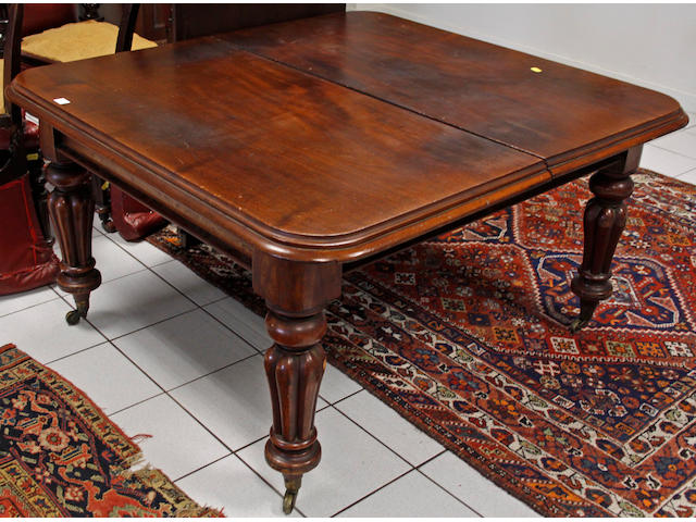 A Victorian mahogany extending dining table,on reeded baluster legs and castors, including two extra leaves, 257 x 132cm