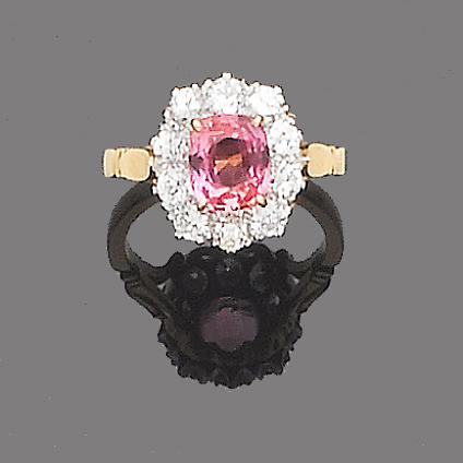 A padparadscha sapphire and diamond cluster ring