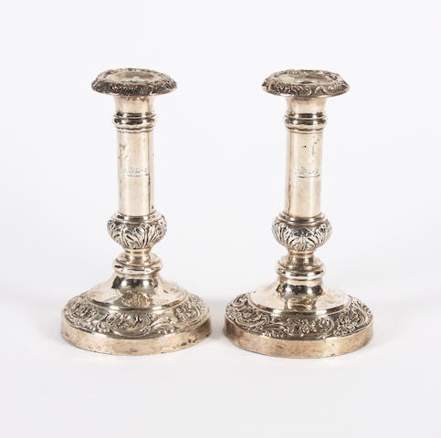A pair of George IV silver candlesticks The bases apparently unmarked, the sconces bearing maker's mark for S. C. Younge and Co, Sheffield, 1820,  (2)