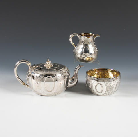 A Victorian silver bachelor's three piece tea set By George Fox, London, 1873,  (3)