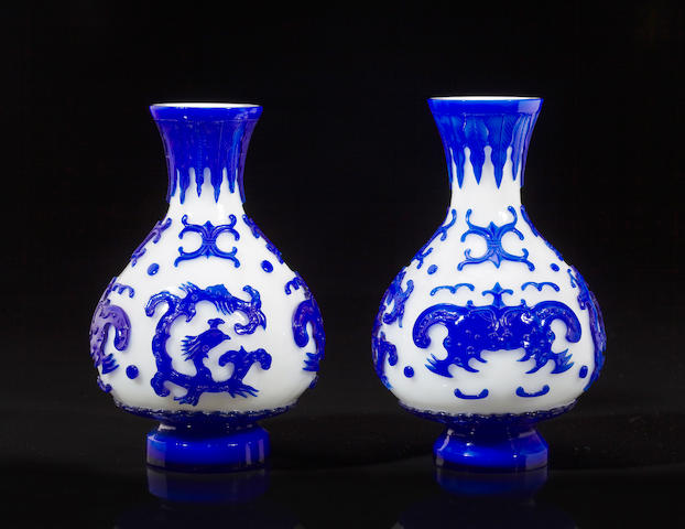 A pair of blue glass overlay 'dragon' vases Qianlong