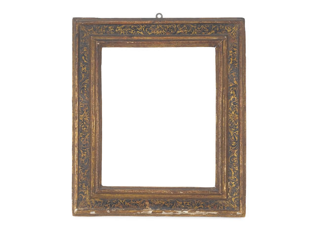 A Spanish 17th Century carved, ebonised and parcel gilt cassetta frame