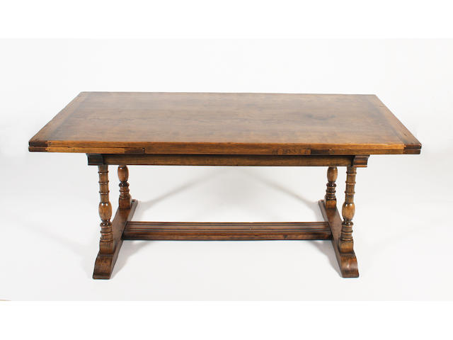 A reproduction, 17th century style, stained oak draw-leaf dining table, by Frederick Tibbenham