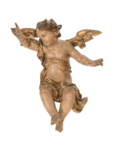 An 18th century carved wood and polychrome decorated figure of a putto