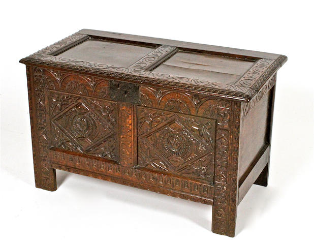 A 17th century carved oak panelled coffer