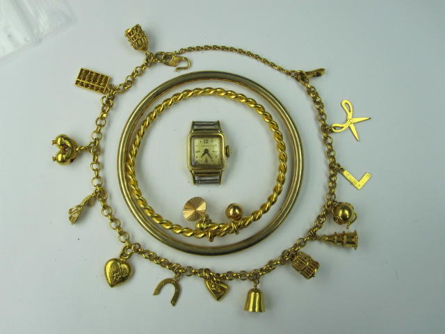 An Eastern yellow precious metal charm bracelet,