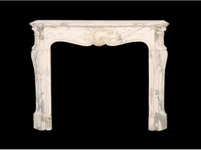 A late 19th century Louis XV style carved marble chimneypiece