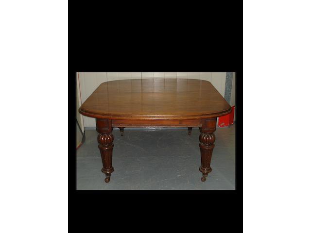 A Victorian mahogany extending dining table and three leaves