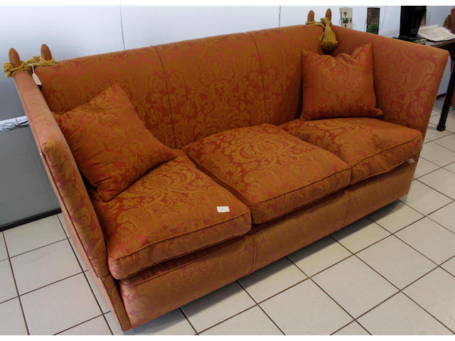 A pair of three seater Knowle type settees, each with feather filled loose cushions in red damask.
