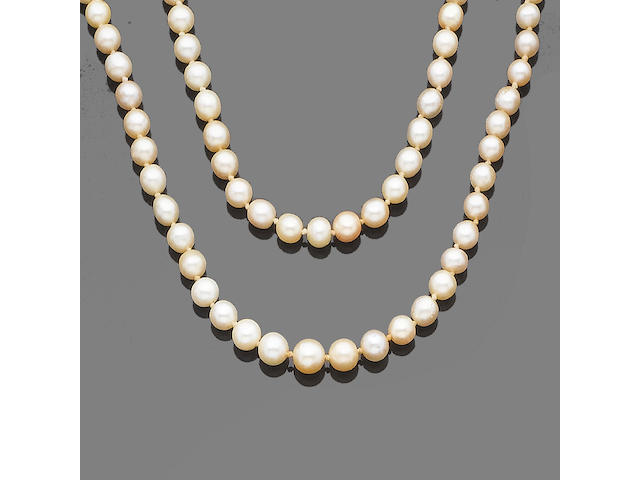 A two-strand pearl and cultured pearl necklace with diamond clasp