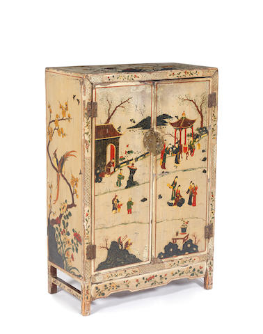 A Chinese ivory ground lacquer dwarf cabinet, 19th Century, enclosed by a pair of doors painted with figures and buildings in a fenced landscape, the top and sides painted with birds and butterflies amongst flowering trees and plants, the interior black gilt decorated with flowering branches on a crimson ground, 62cm.