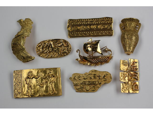 A collection of eight yellow precious metal brooches of Greek designs