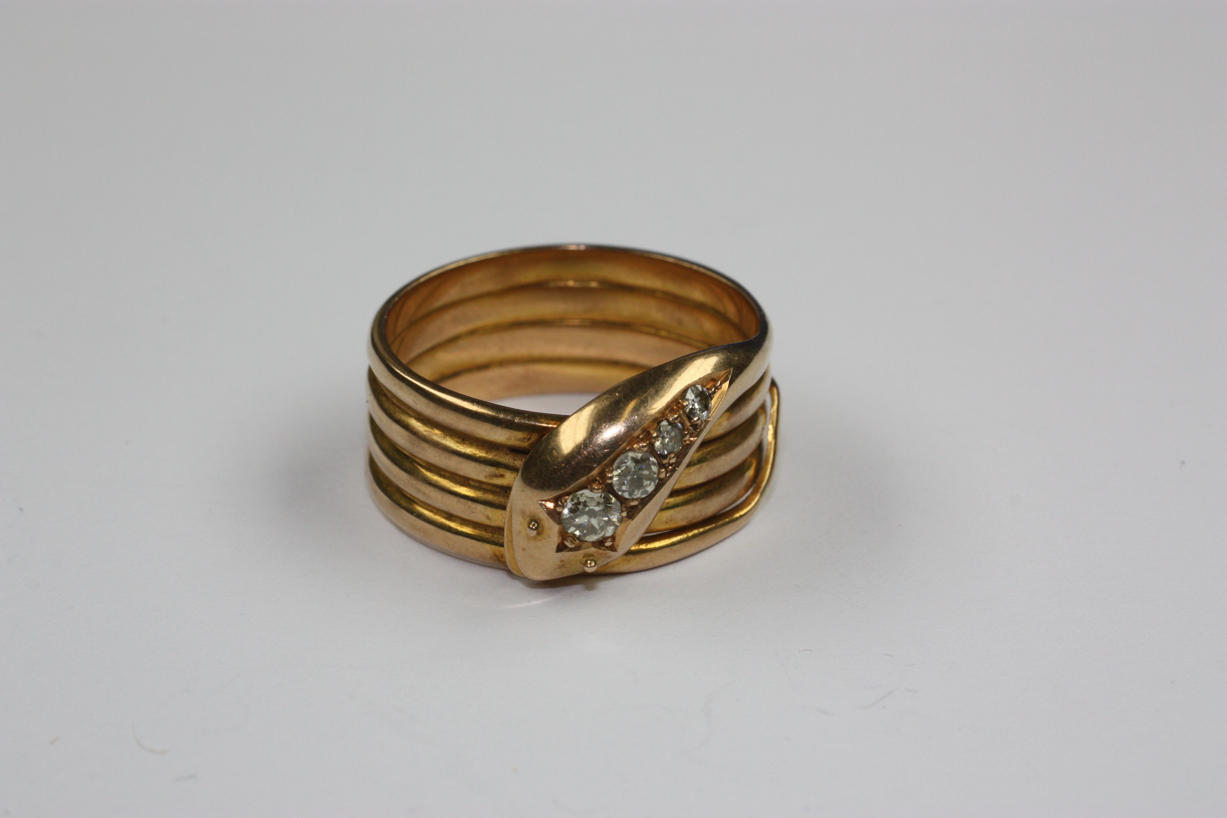 A diamond set coiled serpent ring