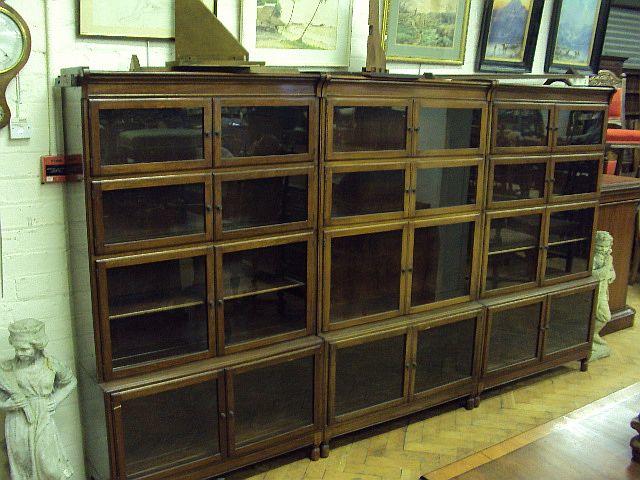 A set of three mahogany bookcases, early 20th Century, by Minty Each bearing ivorine 'Minty' label