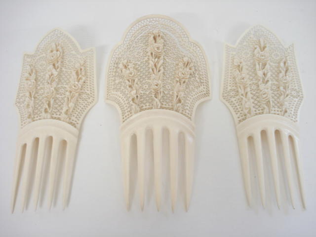 A pair of ivory hair ornaments and another Circa 1900