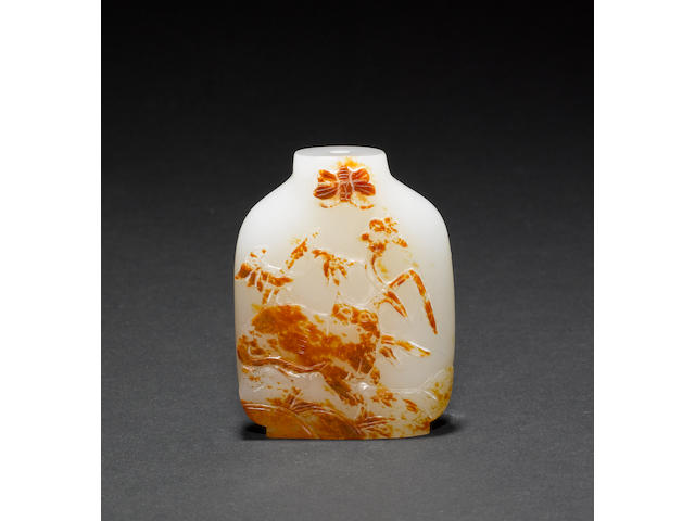A Chinese jade snuff bottle with russet inclusion, carved with a tiger, or other feline beneath a butterfly