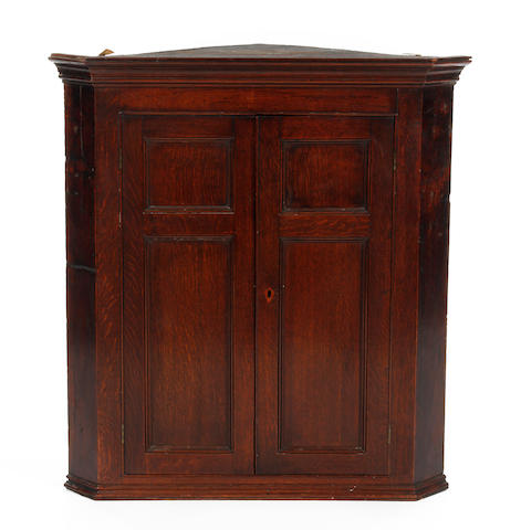 A George III oak corner cupboard