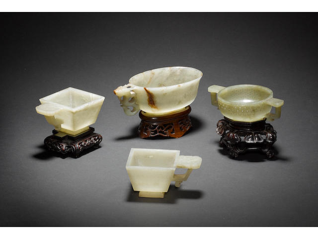 A group of four jade cups; the stone of various celadon hue. Ming or Qing Dynasty