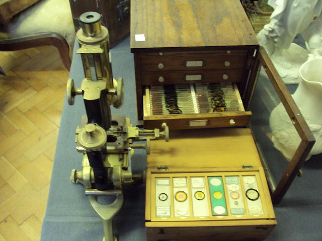 A brass microscope with slides
