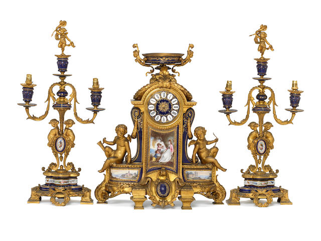 A large mid 19th century porcelain mounted ormolu mantel clock and associated side pieces Japy Freres