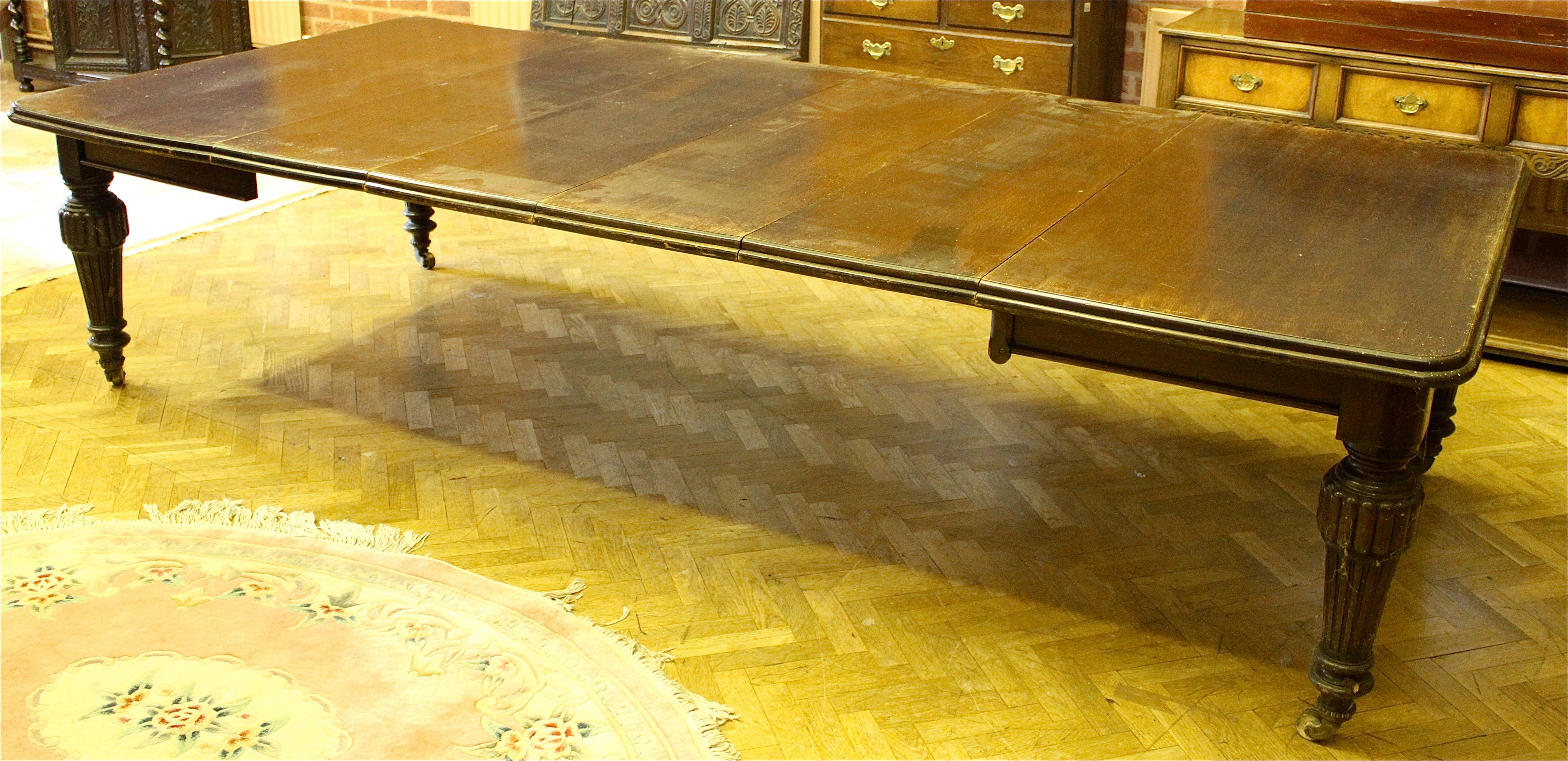 A Victorian oak extending dining table