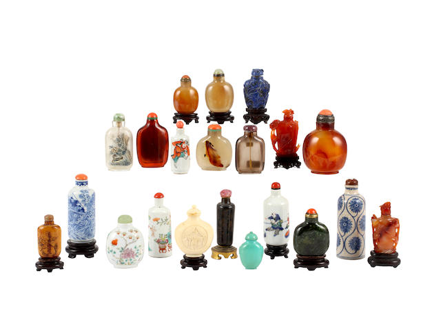 A collection of twenty one Chinese snuff bottles and stoppers and eleven stands, including: