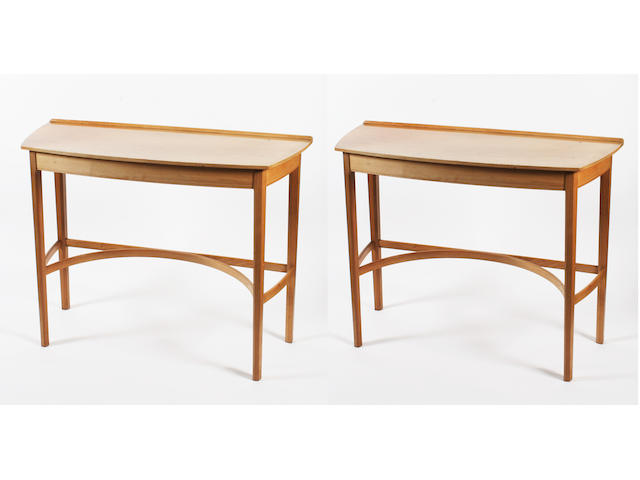 A pair of Barnsley walnut bow front side tables