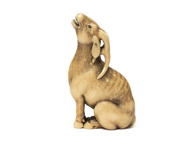 A very fine ivory netsuke of a stag By Okatomo, Kyoto, late 18th/early 19th century