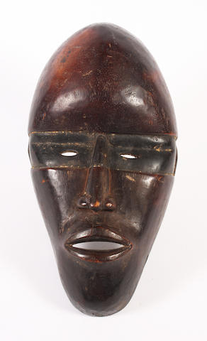 A carved and patinated wood mask, Dan, Ivory Coast