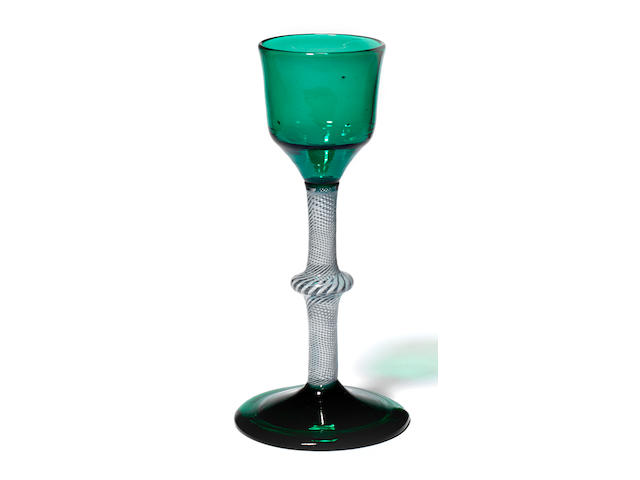 A rare opaque-twist wine glass with emerald-green tinted bowl and foot, circa 1765