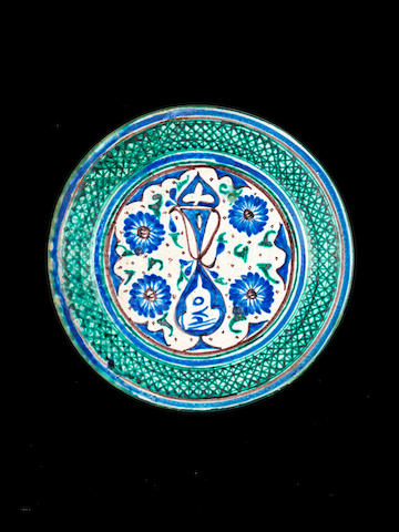 An underglaze-painted pottery Dish probably Bukhara, Central Asia, dated AH 1280/ AD 1863-4