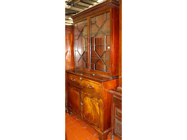 A George III mahogany secretaire bookcase,with astragal glazing above a fitted drawer and cupboard base on brackeet feet, 125cm