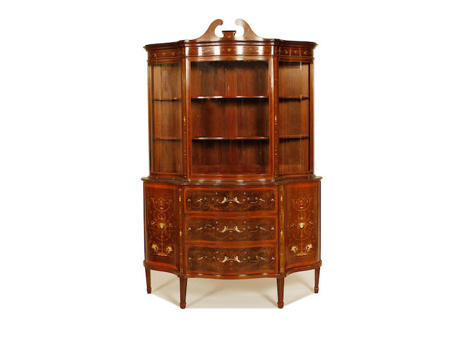 An Edwardian mahogany, satinwood, fruitwood and ivory marquetry serpentine display cabinet by Edwards and Roberts