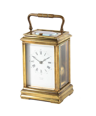 A late 19th century French brass and bevel glass cased carriage clock