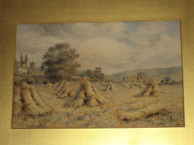 Wilmot Pilsbury RWS (British, 1840-1908) Harvest landscape with cornstooks in a field by a village
