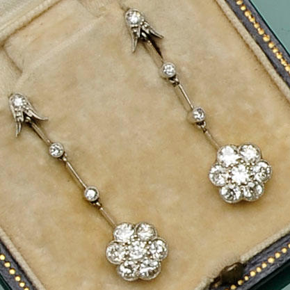 A pair of diamond flowerhead cluster drop earrings