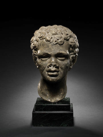 A Roman dark grey marble portrait head of an African youth