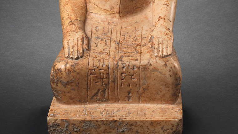An Egyptian indurated limestone statue of a kneeling official image 2
